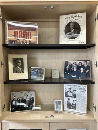 A display case of photographs and archival documents